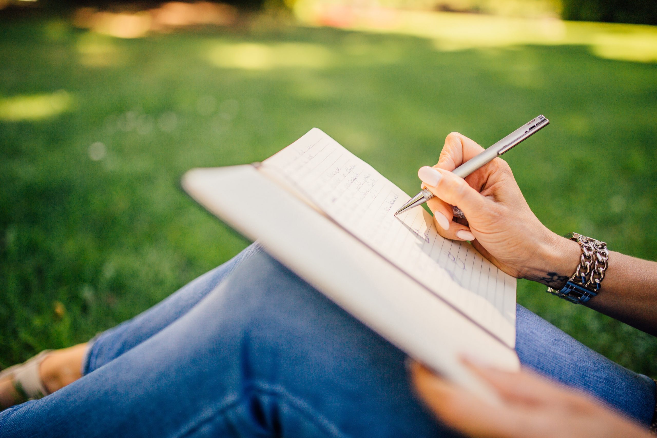 woman writing outdoors